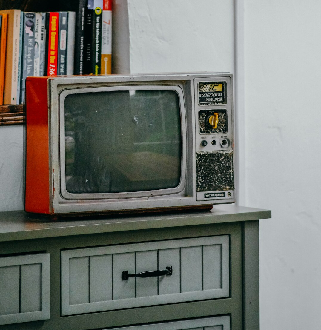 Vintage advertising archive desk with an old television and stacked magazines
